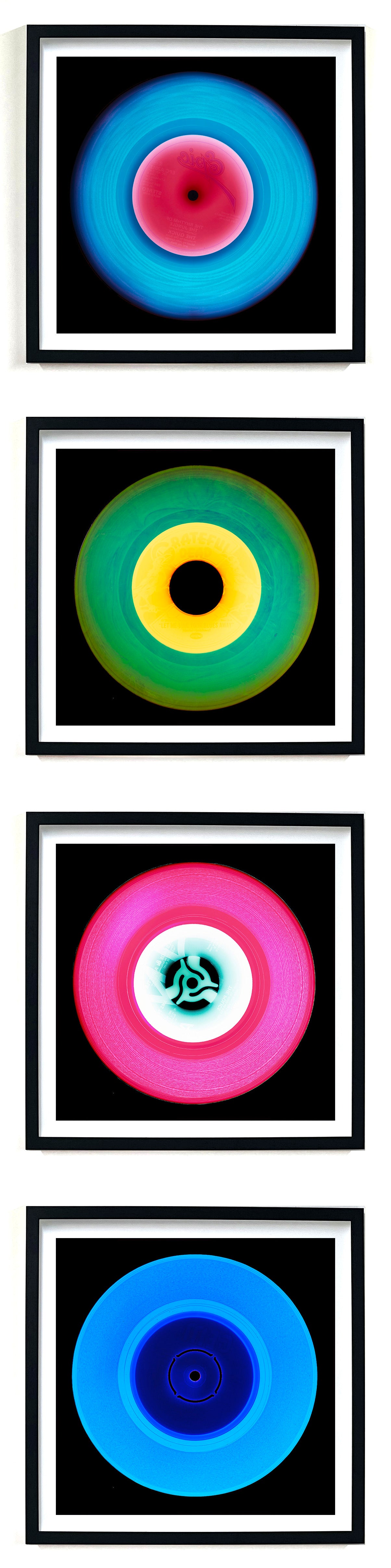 Photographs by Heidler and Heeps. A vertical line of 4 photographs of vinyls in striking colours, with black frames. 
