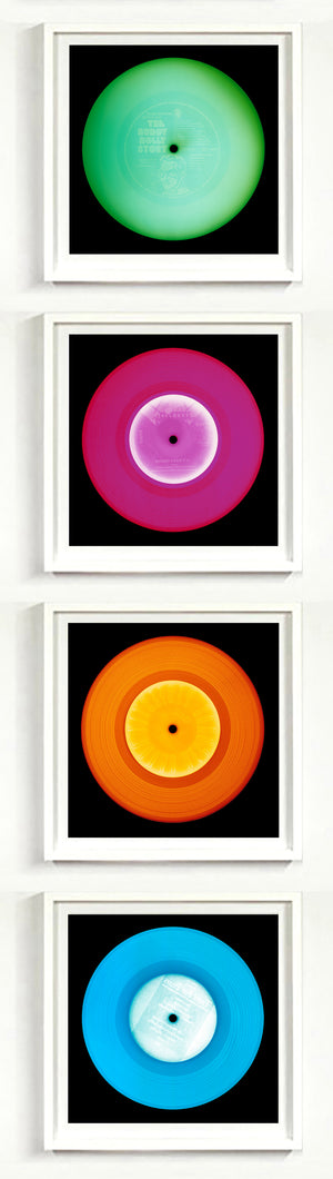 Photographs by Heidler and Heeps. A vertical line of 4 photographs of vinyls in striking colours, with black frames. 