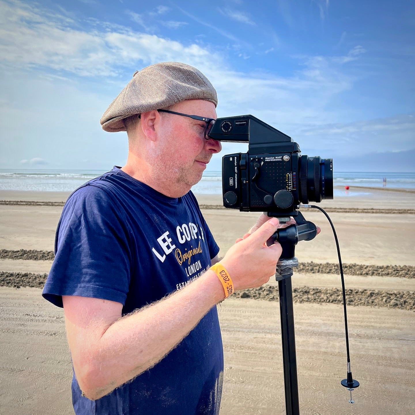 Richard Heeps photographing on Pendine Sands beach with a vintage analogue Mamiya RZ67 camera.