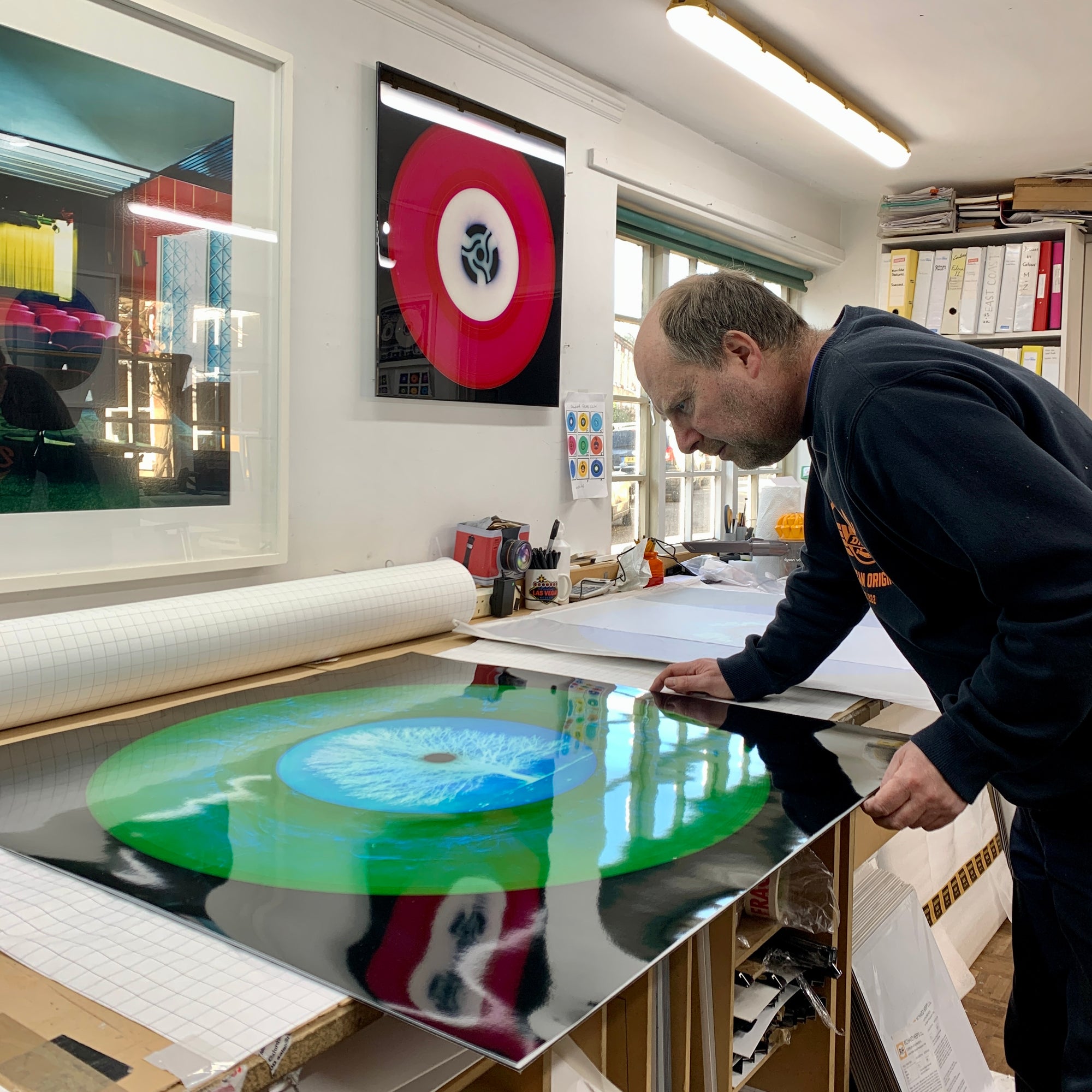 Richard Heeps evaluating photographic prints in his Cambridge home studio.