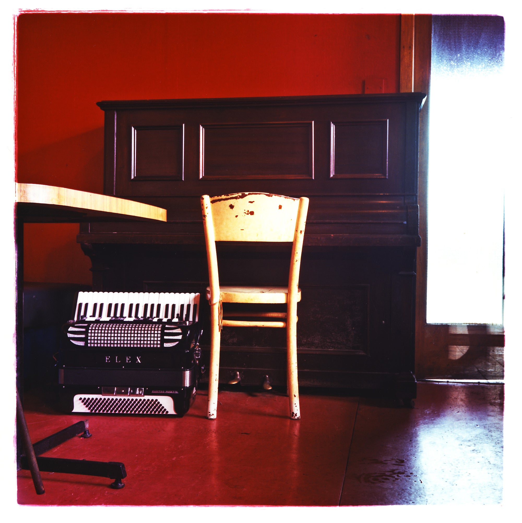 A red music room with a piano and an Elex.