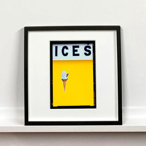 Black framed photograph by Richard Heeps.  Yellow typography print of an ice cream on a yellow colour block with the Kodak film rebate.