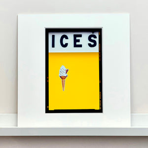 White framed photograph by Richard Heeps.  Yellow typography print of an ice cream on a yellow colour block with the Kodak film rebate.