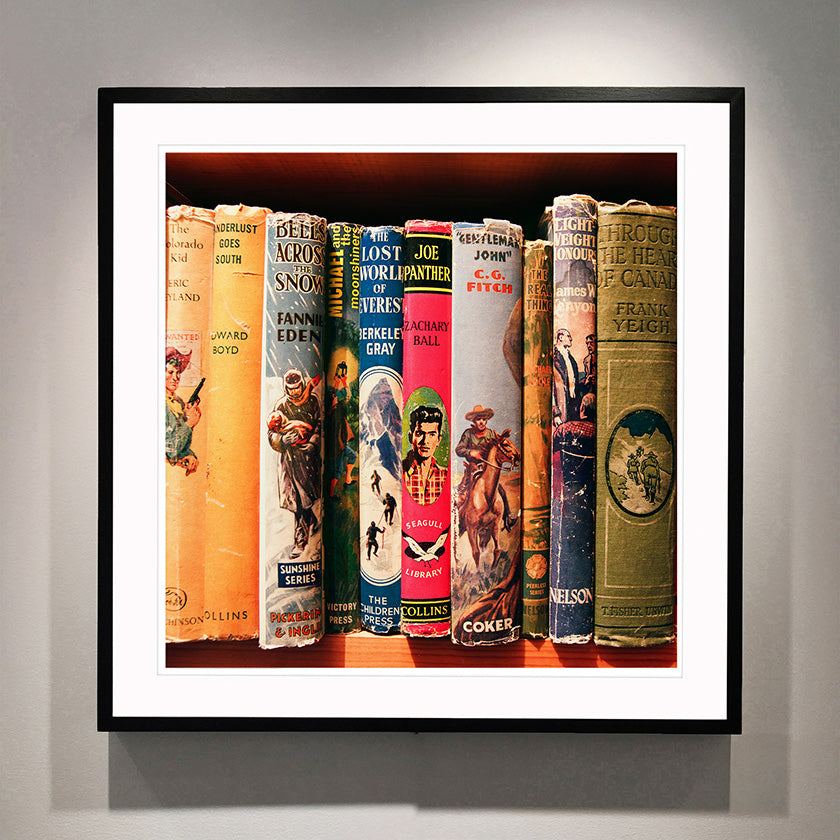 Photograph framed in black of vintage book spines by Richard Heeps.