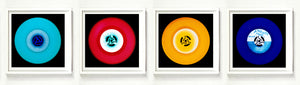 Photographs by Heidler and Heeps. A horizontal line of 4 photographs of vinyls in striking colours, with black frames. 