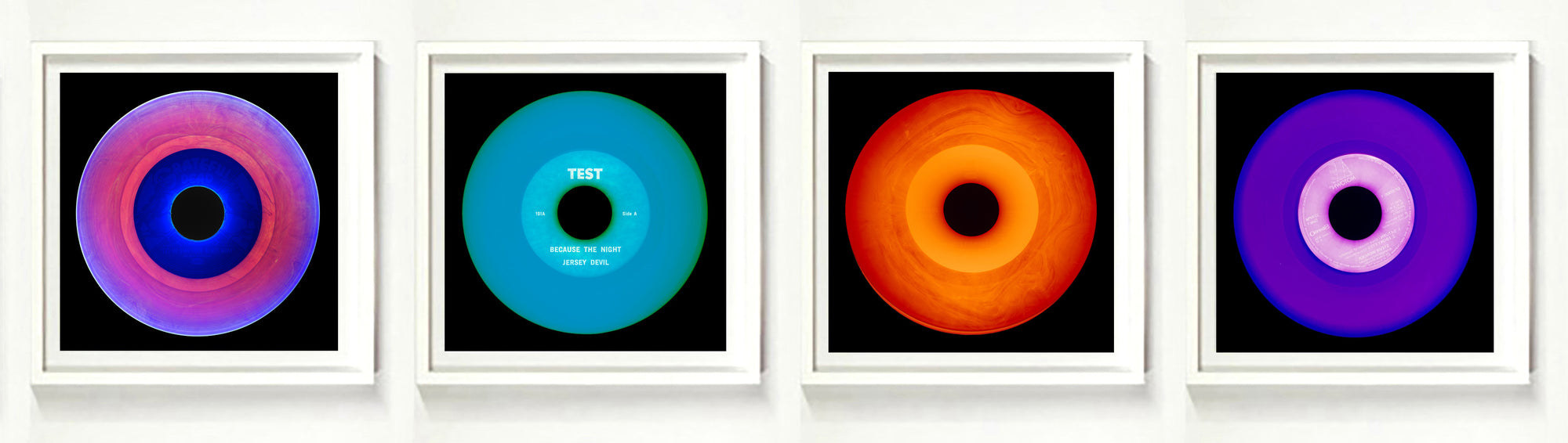 Photographs by Heidler and Heeps. A horizontal line of 4 photographs of vinyls in striking colours, with black frames. 