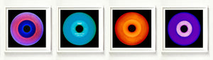 Photographs by Heidler and Heeps. A horizontal line of 4 photographs of vinyls in striking colours, with black frames. 