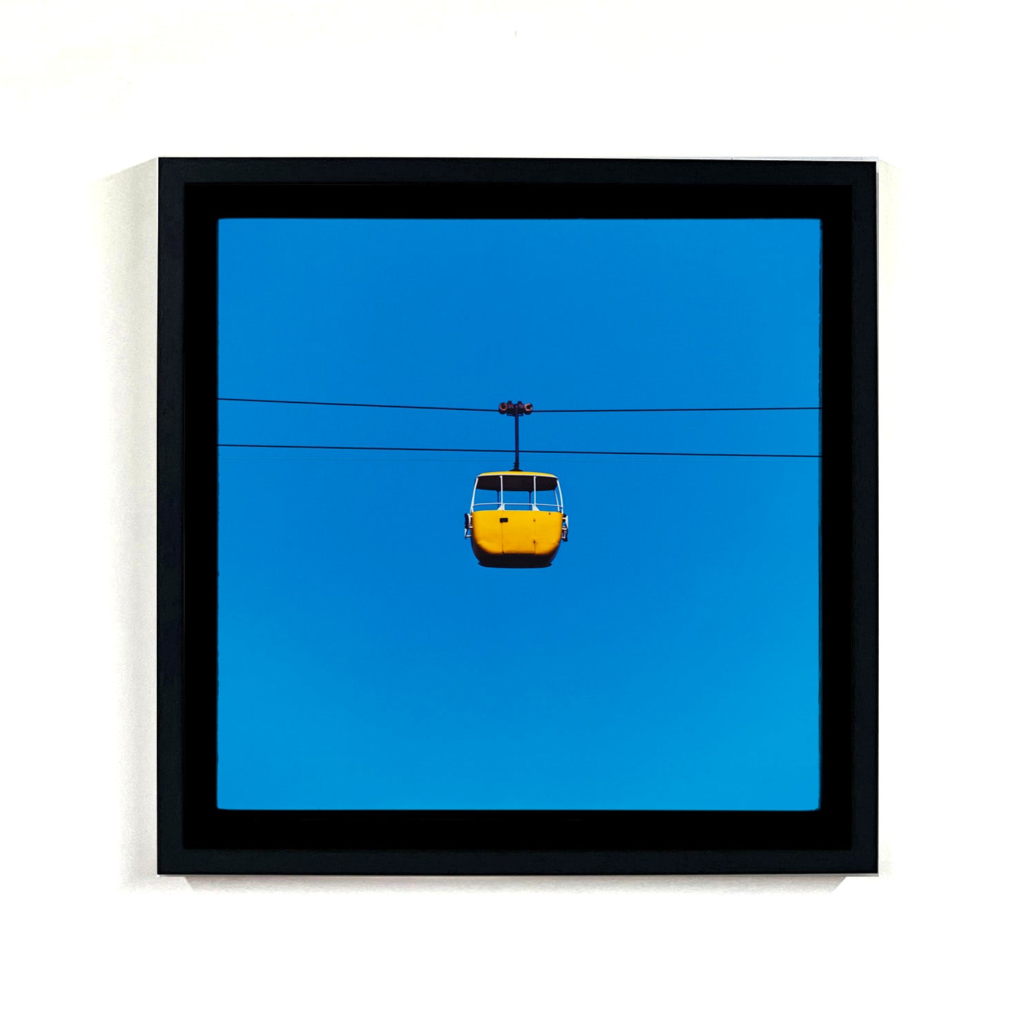 Recently sold artwork Cable Car Yellow blue sky photograph by Richard Heeps framed in black.