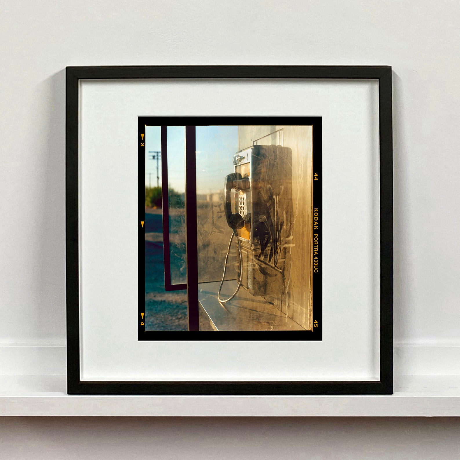 Call Box, cinematic vintage telephone booth road trip mounted photograph in a small black frame from Richard Heeps Salton Sea series.