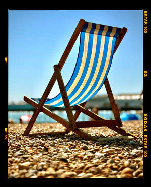 Brighton Beach deck chair on a sunny day photograph by Richard Heeps