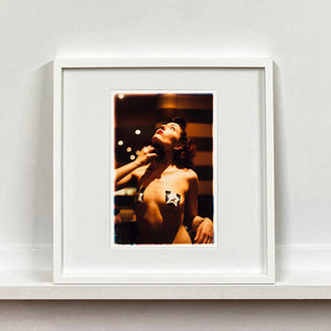 Delilah burlesque backstage photography by RIchard Heeps mounted square framed in white.