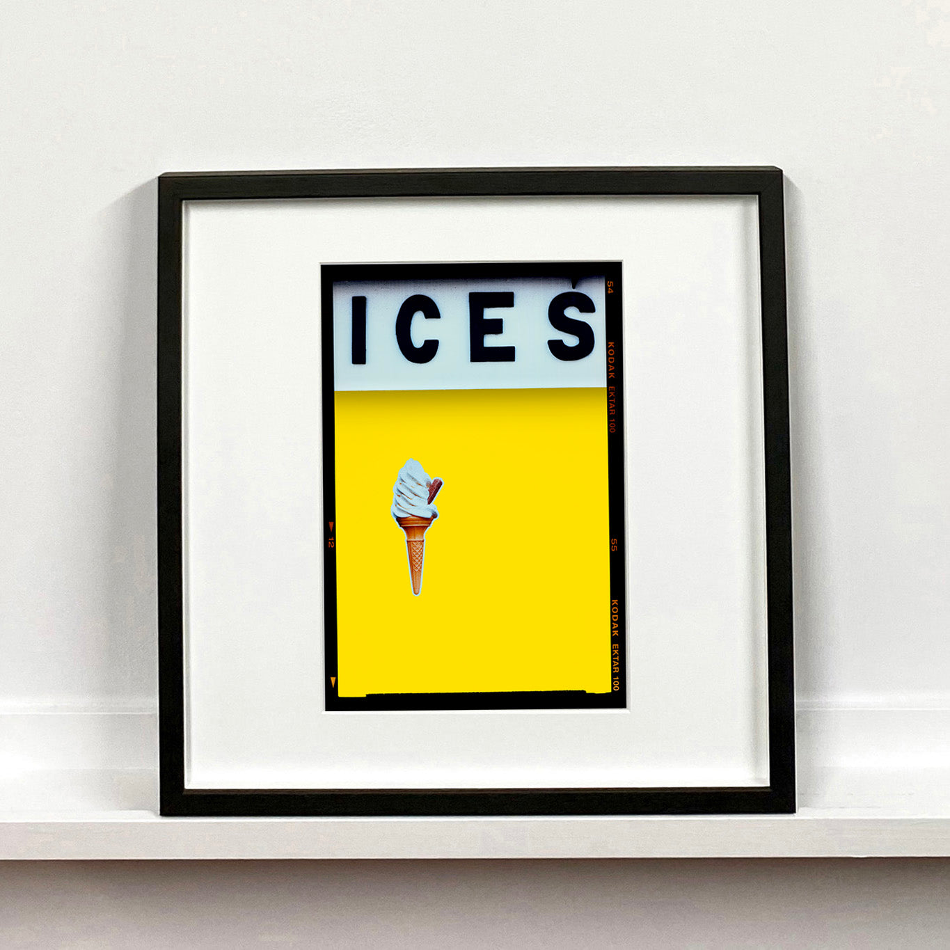 Ices lemon yellow pop art typography colour photography mounted square print by Richard Heeps framed in black.