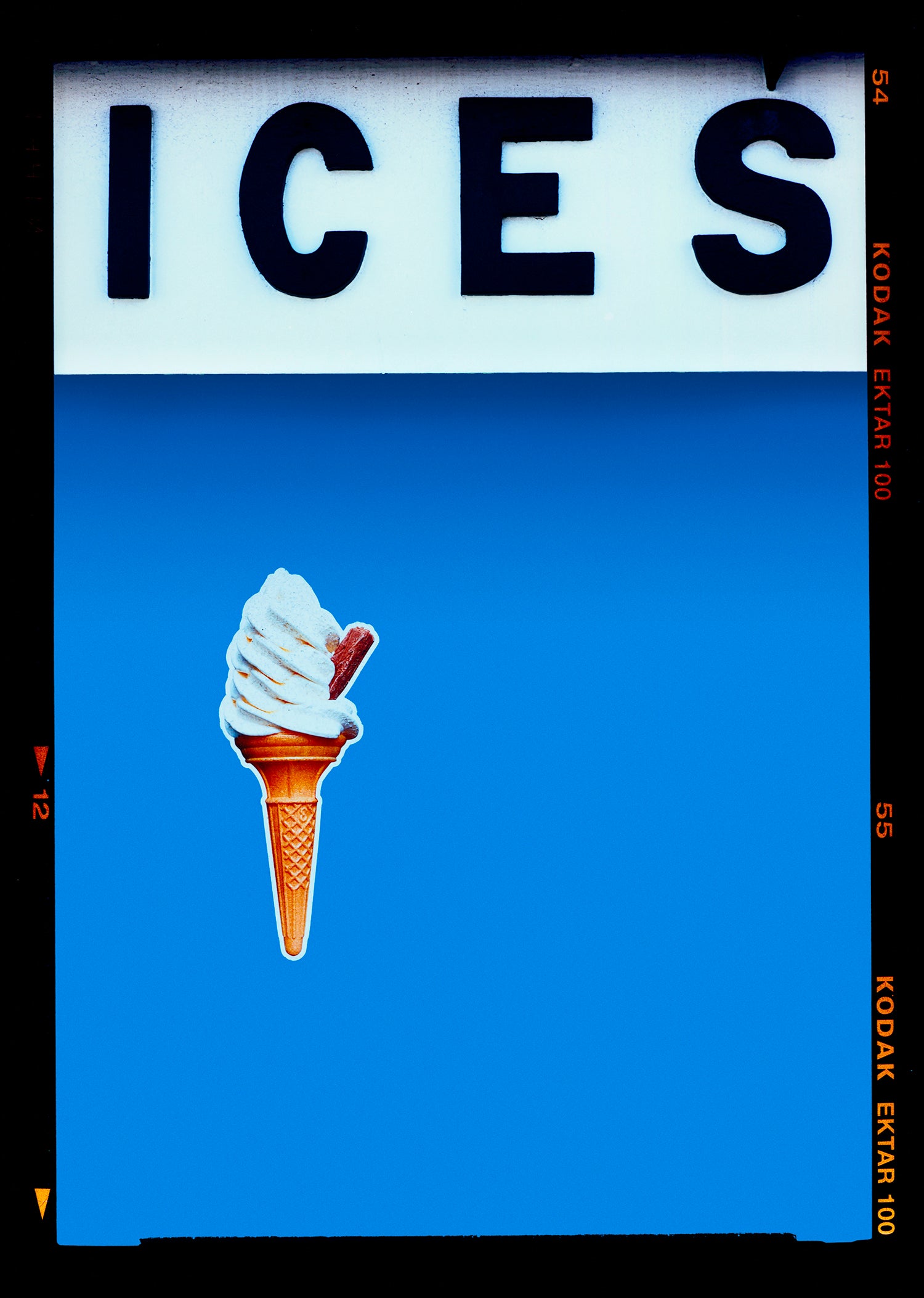 Photograph by Richard Heeps.  At the top black letters spell out ICES and below is depicted a 99 icecream cone sitting left of centre against a sky blue coloured background.  