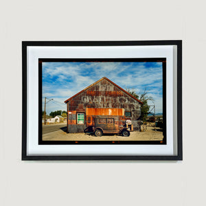 Model T and Garage American road trip colour Kodak Film photograph by Richard Heeps small framed in black