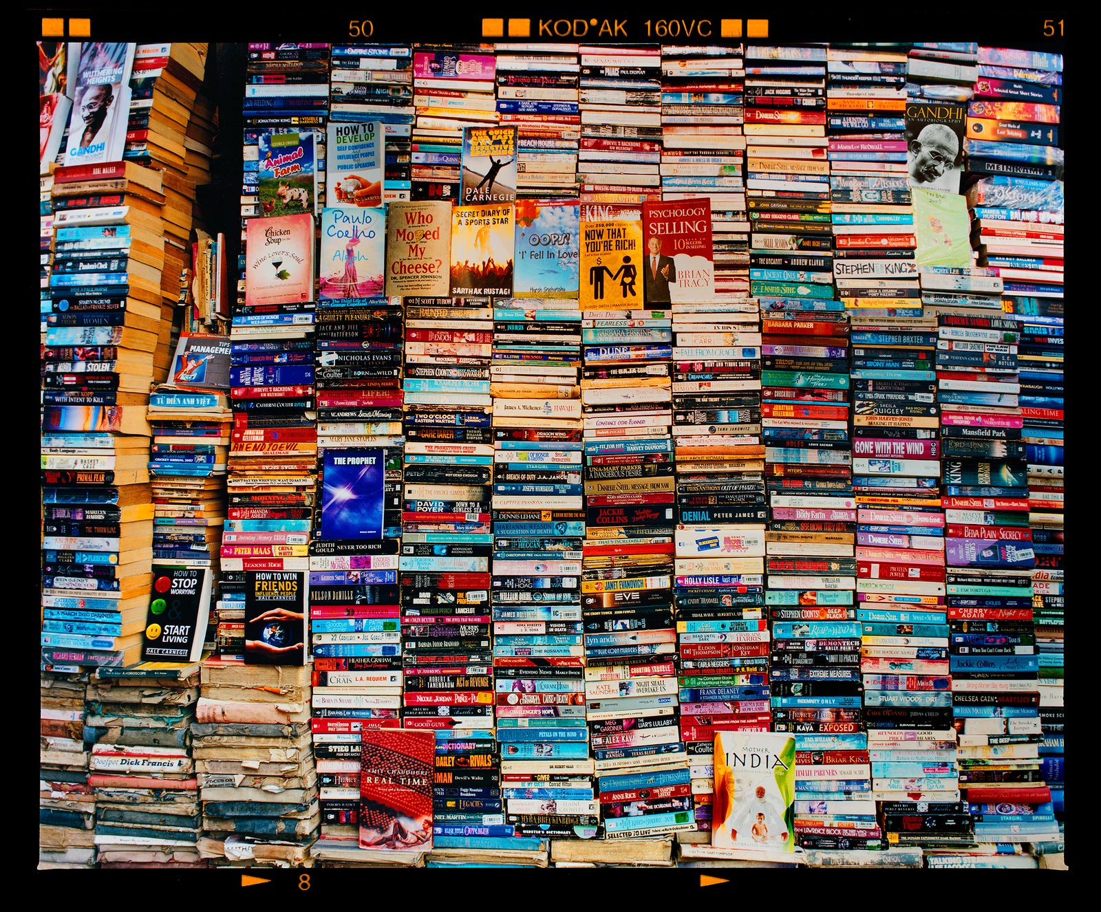 Mother India Delhi street photography multicolour book stack photograph by Richard Heeps