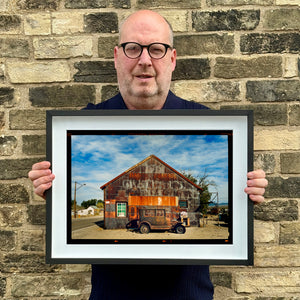 Richard Heeps holding Model T and Garage framed in black