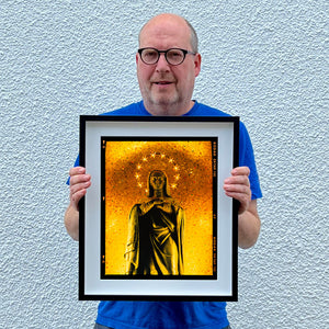 Richard Heeps holding Santa Maria delle Grazie artwork framed in black.
