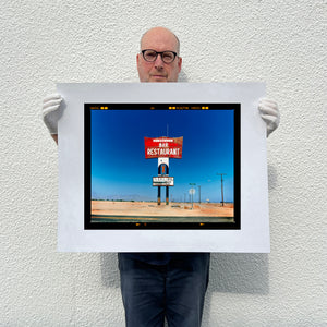Richard Heeps holding Sundowner Landscape Salton Sea California print.