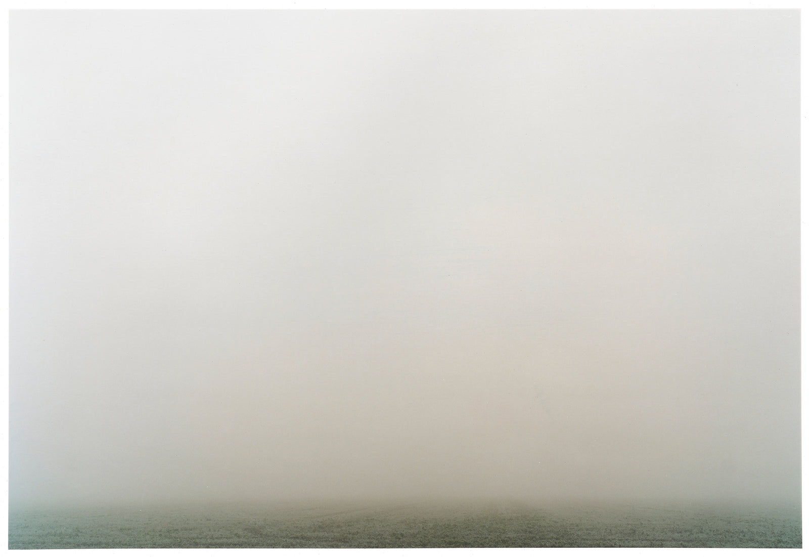 Photograph by Richard Heeps. The photograph is of a wonderfully thick fog and all you can make out is the dark grey of the fenland along the bottom of the photo.