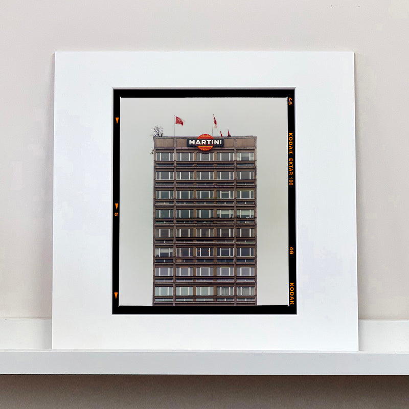 White mounted photograph by Richard Heeps. High rise offices with Martini logo on the top facade. 