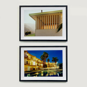 Two black framed photographs by Richard Heeps.  The top photograph is of a corner of the top of a cream colour building with big windows and vertical slats, on the left hand side are mountains bathing in the mist of dawn. The bottom photograph is night time around a hotel pool. The hotel is lit up and this is reflected in the pool.