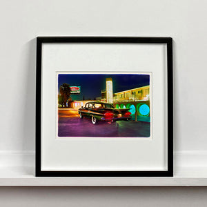 Black framed photograph by Richard Heeps. A Chevy Bel Air is central shot and off to the right are the pools and balcony of the Glass Pool Motel, Las Vegas.