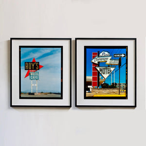 Two black framed photographs by Richard Heeps edged by film rebate. On the left hand side a Route 66 roadside sign. For ROY's MOTEL and CAFE ROY'S. On the right hand side, is a photo of a white sign in the shape of an arrow with Champagne written on it and a white cloud sign above with the word Pink written, at the bottom is a white arrow pointing down with the word MOTEL written. There is also a red block sign on the left hand side and a ONE WAY sign on the right hand side.