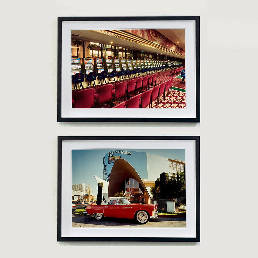 Two black framed photographs by Richard Heeps. The top photograph is one which shows a line of slot machines from a vintage casino in Las Vegas. The photograph at the bottom is a red vintage car sitting outside the Riviera building in Las Vegas.