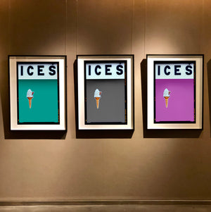 Black framed photograph by Richard Heeps.  At the top black letters spell out ICES and below is depicted a 99 icecream cone sitting left of centre against a Turquoise Teal coloured background.  Set of three photographs by Richard Heeps.  Three identical photographs (apart from the block colour), at the top black letters spell out ICES and below is depicted a 99 icecream cone sitting left of centre set against, in turn, a Turquoise Teal, Grey and Plum kground.  