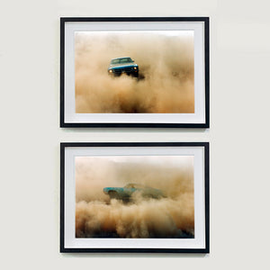 Two black framed photographs by Richard Heeps. The photographs are of a light blue Buick car moving and slightly obscured by the dust clouds which it has created. In the top photograph the car is face on and in the second one the car is sideways on.
