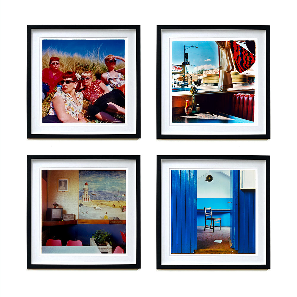 Four photographs by Richard Heeps selected from his Mans Ruin and Ordinary Places series. The photos are of four retro women on a hill, looking out of a window of a retro American diner, inside a retro cafe and a chair sitting alone in a room with blue walls.