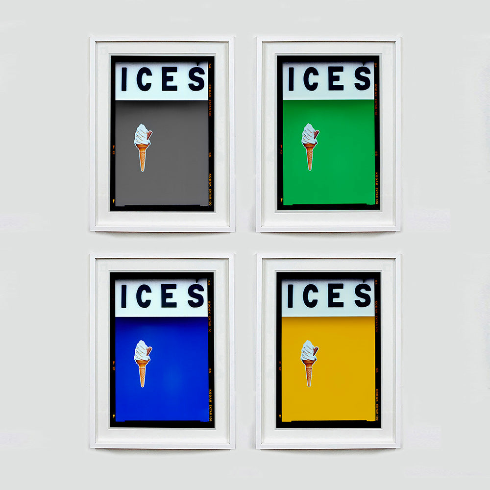 Set of four (2x2) white framed photographs by Richard Heeps.  Four identical photographs (apart from the block colour), at the top black letters spell out ICES and below is depicted a 99 icecream cone sitting left of centre set against, in turn, grey, green, blue, mustard yellow coloured background.  