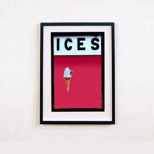 Black framed photograph by Richard Heeps.  At the top black letters spell out ICES and below is depicted a 99 icecream cone sitting left of centre against a raspberry coloured background.  