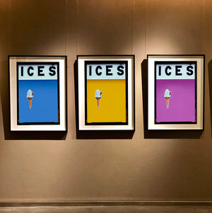 Set of three photographs by Richard Heeps.  Three identical photographs (apart from the block colour), at the top black letters spell out ICES and below is depicted a 99 icecream cone sitting left of centre set against, in turn, a baby blue, mustard and plum coloured background.  
