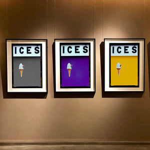 Set of three photographs by Richard Heeps.  Three identical photographs (apart from the block colour), at the top black letters spell out ICES and below is depicted a 99 icecream cone sitting left of centre set against, in turn, a grey, purple and mustard yellow coloured background.  