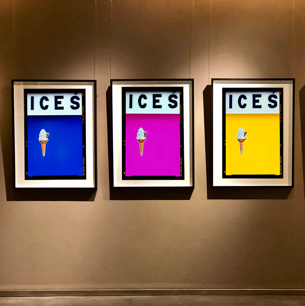 3 Black framed photographs by Richard Heeps. Hanging on a brown wall, 3 photographs of prints of an ice cream on a colour block (blue, pink and yellow) with ICES written across the top of each and each has a Kodak film rebate.