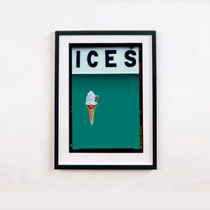 Black framed photograph by Richard Heeps.  At the top black letters spell out ICES and below is depicted a 99 icecream cone sitting left of centre against a deep green teal coloured background.  