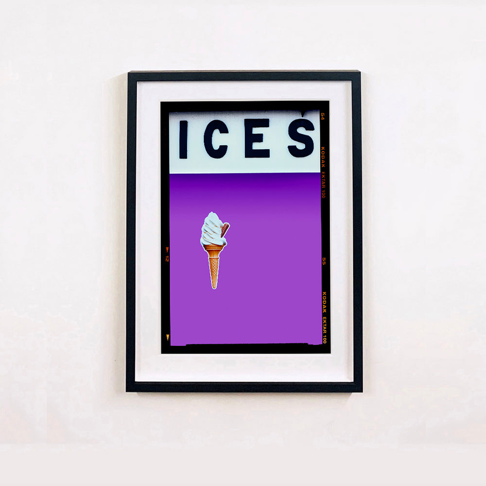 Black framed photograph by Richard Heeps.  At the top black letters spell out ICES and below is depicted a 99 icecream cone sitting left of centre against a lilac coloured background.  