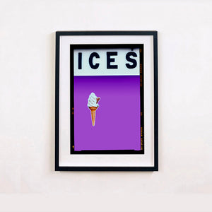 Black framed photograph by Richard Heeps.  At the top black letters spell out ICES and below is depicted a 99 icecream cone sitting left of centre against a lilac coloured background.  