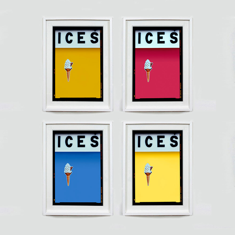 Set of four (2x2) white framed photographs by Richard Heeps.  Four identical photographs (apart from the block colour), at the top black letters spell out ICES and below is depicted a 99 icecream cone sitting left of centre set against, in turn, a mustard yellow, raspberry, baby blue and sherbert yellow coloured background.  