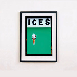 Black framed photograph by Richard Heeps.  At the top black letters spell out ICES and below is depicted a 99 icecream cone sitting left of centre against a viridian green coloured background.  