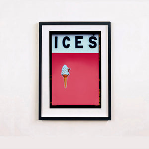 Black framed photograph by Richard Heeps.  At the top black letters spell out ICES and below is depicted a 99 icecream cone sitting left of centre against a coral coloured background.  