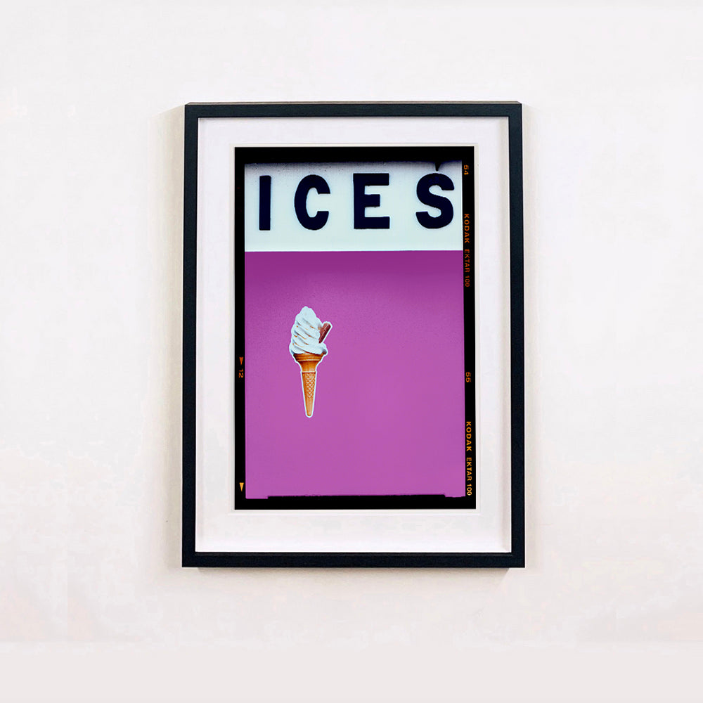 Black framed photograph by Richard Heeps.  At the top black letters spell out ICES and below is depicted a 99 icecream cone sitting left of centre against a plum coloured background.  