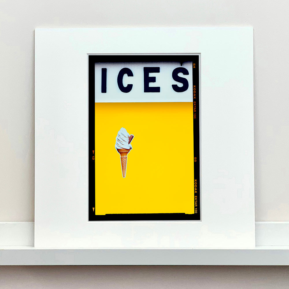 White framed photograph by Richard Heeps.  Yellow typography print of an ice cream on a yellow colour block with the Kodak film rebate.