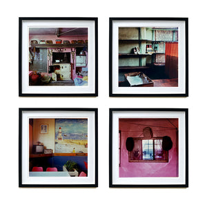 Four Black framed photographs by Richard Heeps. There are four photographs from the Ordinary Places series. The first is of a retro kitchen with an aga, the second one is of an abandoned shoe shop, the third one is in a cafe, the fourth is of some hats sitting around a mirror against a pink wall.
