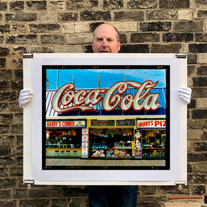 Photograph held by photographer Richard Heeps. Harry's Corner was taken on the wildwood boardwalk, featuring neon typography and the iconic Coca-Cola sign against a bright blue sky. 