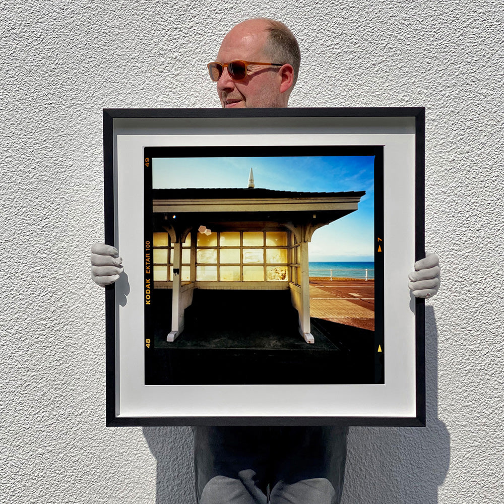 Seafront Shelter, British seaside architecture photograph by Richard Heeps print in a black frame.