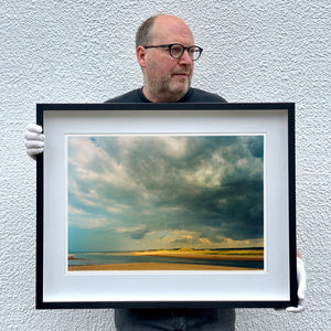 Richard Heeps holding View from Scolt Head of Gun Hill Norfolk landscape photographic artwork framed in black