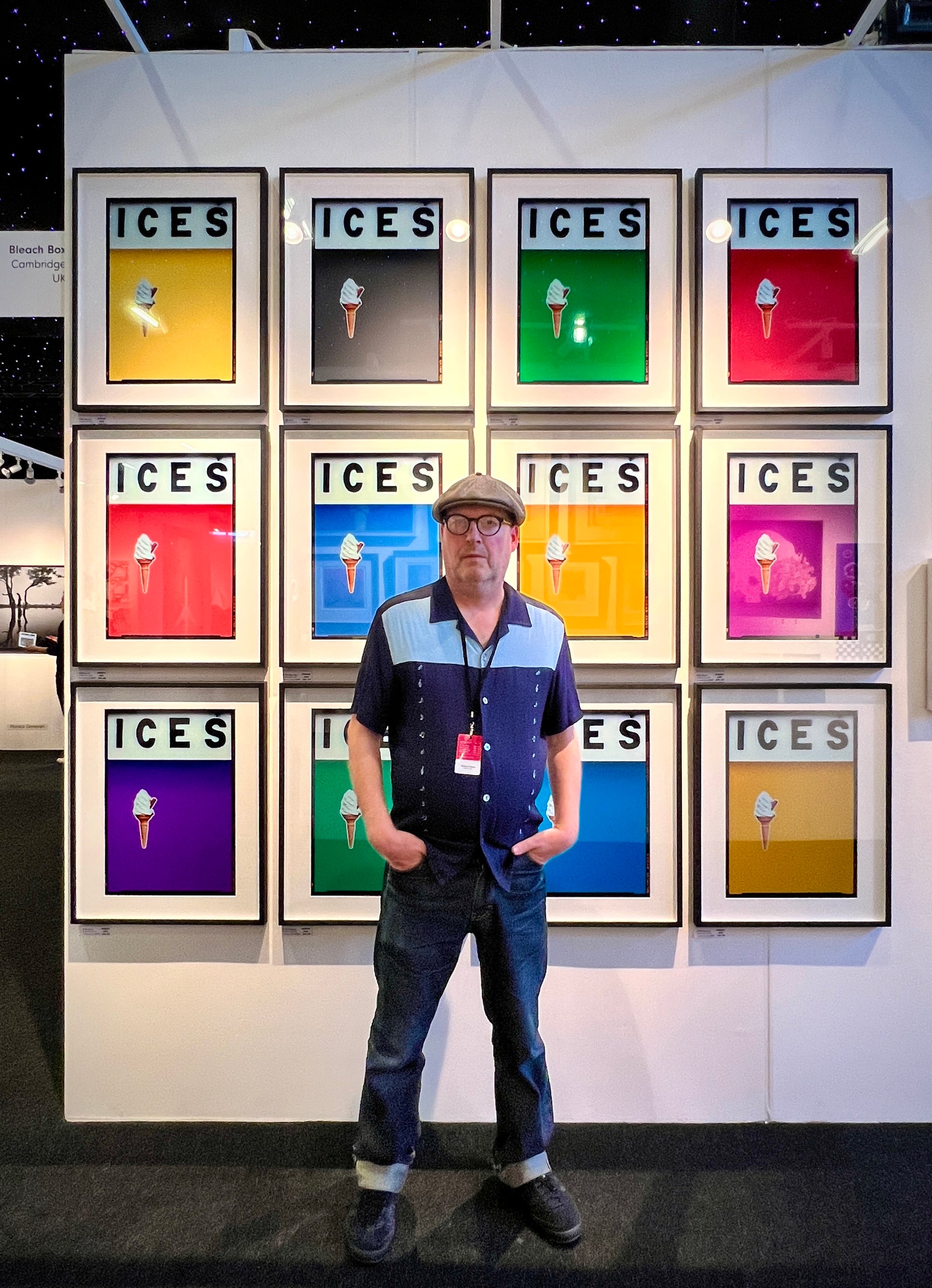 Richard Heeps with a wall of multicolour ices framed in black at the Affordable Art Fair Battersea Park London