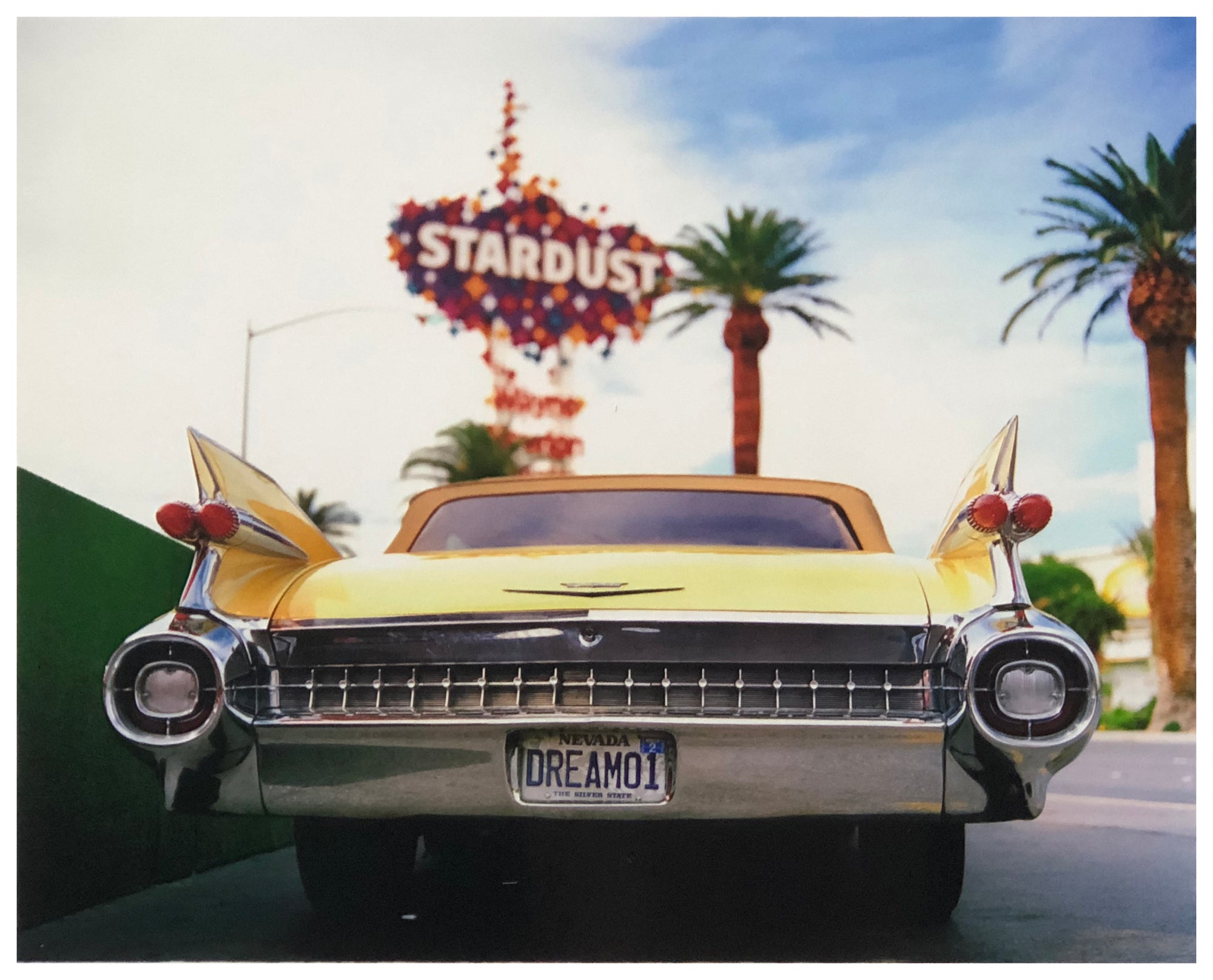 Photograph by Richard Heeps.  The back end of the classic American car with a number place DREAM01 sits underneath the STARDUST casino sign.